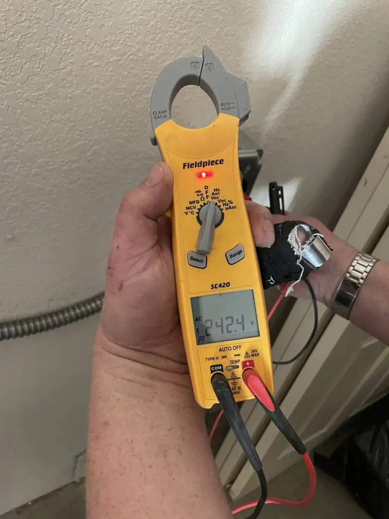 Voltage testing with clamp meter during Outlet Installation in Auburn